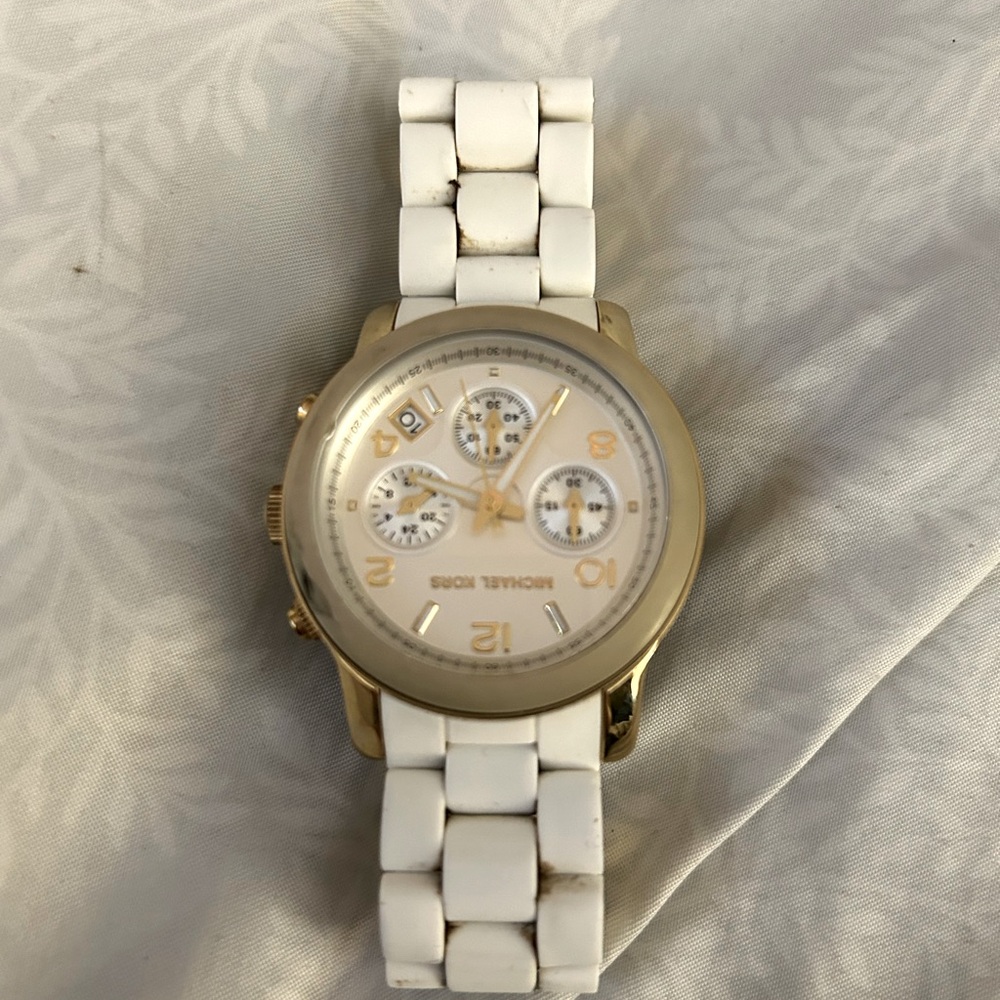 Michael Kors watch with gold bezel.